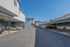 Spacious open-air parking facility with clean, well-maintained carports under a clear blue sky, offering ample space and convenience.