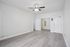 Bright, open space with sleek hardwood floors and ceiling fan, perfect for a modern living room setup.