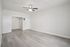 Bright and inviting living room with modern ceiling fan and elegant light wood flooring.