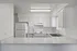 Bright and modern kitchen with sleek white cabinetry, spacious countertop, and contemporary appliances.
