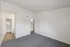 Bright room with plush carpeting, white walls, and a walk-in closet for modern living.