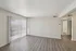 Bright living room with sleek hardwood floors and large sliding glass doors, perfect for natural light and an open atmosphere.
