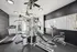 Modern apartment gym featuring top-notch workout equipment, including a treadmill, stationary bike, and multi-functional weight machine, in a bright and inviting space.