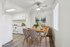 Charming kitchen and dining area with a modern touch, featuring sleek chairs, stylish table setting, and a bright, airy atmosphere.