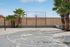 Inviting outdoor basketball court with palm trees and a clear blue sky, perfect for active living.