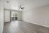 Bright, modern living space with sleek hardwood floors, sliding patio doors, and ceiling fan, perfect for comfortable living and entertaining.