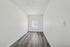 Bright, minimalist room with modern wood flooring and a large window perfect for natural light.