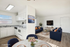 Bright, open-concept living space featuring a modern kitchen, elegant dining area, and spacious lounge with stylish décor.