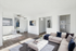 Virtually staged modern apartment showcasing a chic living room with a plush corner sofa, stylish decor, and an airy open-concept dining area.