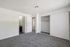 Bright and spacious bedroom with plush carpeting, large closet, and en-suite bathroom for modern living.