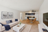 Bright and inviting open-plan living room with elegant white sofa, stylish dining area, and modern kitchen, perfect for comfortable living.