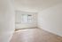Bright minimalist room with textured ceilings and large window, ideal for a serene living space.