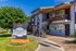 Charming Bonanza Gardens apartment complex with lush greenery, modern balconies, and inviting pathways.