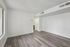 Bright and airy living space with modern gray flooring and crisp white walls, perfect for a contemporary lifestyle.