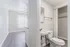 Bright, airy apartment featuring sleek flooring, a modern bathroom with built-in closet, and a sunlit living space.