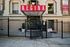Charming apartment entrance with secure gated access and vibrant signage.