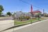 Inviting entrance of Desert Sky mobile home community featuring well-maintained landscaping, vibrant flags, and a welcoming atmosphere in a serene setting.