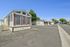 Charming mobile home with classic shutters and inviting steps nestled in a peaceful community setting.