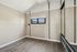 Bright and airy room with vaulted ceiling, stylish wood flooring, and a modern mirrored closet.