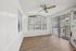 Bright and airy room with sleek wood flooring, large windows, and sliding glass doors, perfect for a welcoming living space.