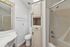 Inviting bathroom boasting elegant cabinetry, a sleek sink, and a modern shower enclosure.