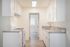 Bright, modern kitchen with sleek countertops, white cabinetry, and contemporary fixtures.