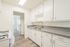 Bright, modern kitchen with sleek countertops, ample white cabinetry, and stainless steel fixtures.