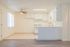 Bright and airy kitchen and dining area with sleek white cabinets, modern ceiling fan, and large window perfect for natural light.