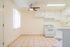 Bright and airy kitchen with sleek white cabinets, modern appliances, and tile flooring, perfect for culinary creativity.
