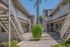 Charming apartment complex with modern staircases and lush greenery, offering a serene living environment.