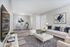 Inviting living room with elegant white sofa, chic abstract art, and modern glass dining table, perfect for effortless entertaining.