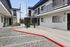 Charming courtyard view of a modern apartment complex with stylish railing and convenient mailbox access.