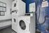 Modern laundry room with stackable washers and dryers, offering efficient and convenient laundry services.