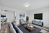 Modern living room with elegant decor, featuring a comfortable sofa, stylish armchairs, and a sleek entertainment center, perfect for relaxing and entertaining.