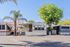 Charming mobile home nestled in a serene neighborhood with lush palm trees, offering a cozy and inviting outdoor space.