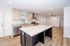 Modern open-concept kitchen with elegant marble island, stainless steel appliances, and inviting hardwood floors, perfect for entertaining.