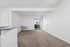 Bright and inviting living area with plush carpeting, sliding glass door leading to a balcony, and a cozy atmosphere perfect for relaxation.