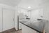 Modern kitchen with sleek countertops and ample cabinetry, featuring a stylish open-plan design.