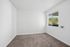 Bright, inviting room with plush carpet, large window offering natural light and scenic views.