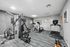 Modern fitness center equipped with state-of-the-art exercise machines including a treadmill, stationary bikes, and a multifunctional weight machine.