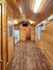 Charming cabin interior with warm wood paneling, modern kitchen appliances, and an inviting open floor plan.