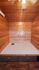 Cozy wooden cabin interior with warm wood paneling, ceiling fan, and built-in storage drawers.