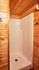 Charming wooden shower unit in a cozy cabin-like setting, offering a warm and inviting atmosphere for relaxation.