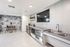 Clubroom Lounge and Dining Area with large kitchen with island and stainless steel appliances at arte apartments