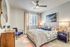 bedroom with ceiling fan bed and night stands at arte apartments