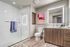 full bathroom with glass doors vinyl wood like flooring at arte apartments