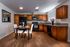 Fully staged modern kitchen and dining area