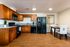 Fully staged modern kitchen and dining area with top of the line appliances