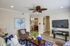 living room with ceiling fan leading to the dining room, kitchen & upstairs