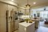 fully stocked kitchen with white cabinets and kitchen island